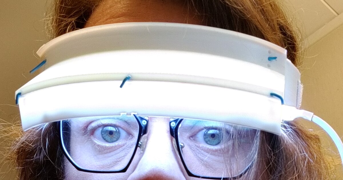 The Circadius 3D-printed light-therapy visor, glowing, worn on the head